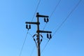 Electrical power line utility pole made of strong concrete with multiple ceramic insulators connecting and holding wires Royalty Free Stock Photo