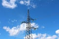 Electrical power line utility pole with multiple electrical wires connected with glass insulators in front of cloudy blue sky