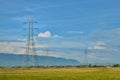 views of rice fields with highvoltage electric towers blue skies and beautiful green rice fields