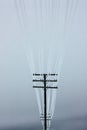 Electrical power lines with hoarfrost on the wooden electric poles on countryside in the winter Royalty Free Stock Photo