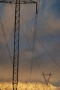 Electrical power lines and towers with snowy mountain shrouded in clouds Royalty Free Stock Photo