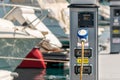 Electrical power sockets bollard on pier near sea coast. Charging station for boats in Mediterranean. Electrical outlets to charge Royalty Free Stock Photo