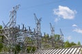 Electrical power substation surrounded by trees in an urban area, blue sky with clouds Royalty Free Stock Photo