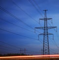 Electrical pylon and high voltage power lines at night. Royalty Free Stock Photo