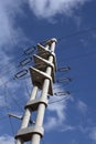 An electrical pylon stands tall against the blue sky. Royalty Free Stock Photo