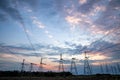 Electrical pylons and high voltage power lines at sunset background. Group silhouette of transmission towers Royalty Free Stock Photo