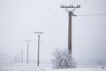Electrical pylons high voltage wires in winter covered snow Royalty Free Stock Photo