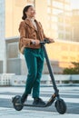 Electrical scooter, woman and city travel on eco friendly transportation, sustainability and clean carbon footprint in