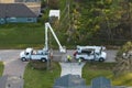 Electrical service company restoring power repairing damaged power lines after hurricane Ian in Florida suburban area