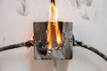 Electrical short circuit. Cable wiring is on fire, splitter is self-igniting Royalty Free Stock Photo