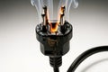 Bad electrical connection in plug starting a fire in a socket outlet. Royalty Free Stock Photo