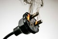 Bad electrical connection in plug starting a fire in a socket outlet. Royalty Free Stock Photo