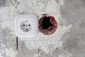 Electrical socket hole on concrete wall. Under construction electrical socket close up Royalty Free Stock Photo