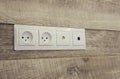 Electrical sockets on a wooden wall