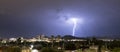 Purple Blue light illuminates the sky over the buildings homes and hills around Tucson Arizona Royalty Free Stock Photo