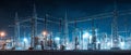 Electrical substation lit at night with intense lighting showcasing power infrastructure Royalty Free Stock Photo