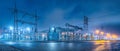 Electrical substation at night with illuminated structures and power lines in a quiet urban setting Royalty Free Stock Photo