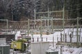 Electrical substation in winter with snow covered transformers and isolators Royalty Free Stock Photo