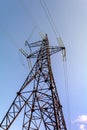 Electrical supports for high voltage cables. A metal support with high voltage insulators against the background of a clear sky. Royalty Free Stock Photo