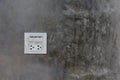 Electrical switches and sockets on the cement wall. Royalty Free Stock Photo