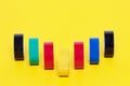 Electrical tapes isolated. Close-up of a set of colorful rolls of insulation adhesive tapes on a yellow background. Macro