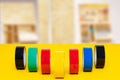 Electrical tapes isolated. Close-up of a set of colorful rolls of insulation adhesive tapes on a yellow desk in front of blurred