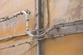 ELECTRICAL AND TELEPHONE CABLES mounted externally on a building wall Royalty Free Stock Photo
