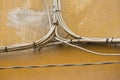 ELECTRICAL AND TELEPHONE CABLES mounted externally on a building wall Royalty Free Stock Photo