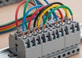 Electrical terminal block with colored wires in a DIN rail setup. The block is segmented for Royalty Free Stock Photo