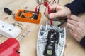 Hands of the electrician check the broken iron with the meter. Royalty Free Stock Photo