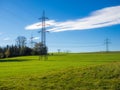 Electrical Tower on a field blue sky green grass Royalty Free Stock Photo