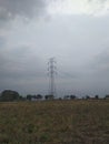 Electrical tower on field , cloudy sky background