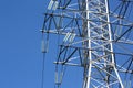 Electrical tower with voltage transmission wires against the background of blue sky. High voltage tower. power line support with Royalty Free Stock Photo