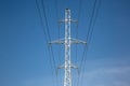 Electrical tower with voltage transmission wires against the background of blue sky. High voltage tower. power line support with Royalty Free Stock Photo