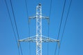 Electrical tower with voltage transmission wires against the background of blue sky. High voltage tower. power line support with Royalty Free Stock Photo