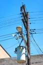 Electrical transformer attached to the electric post with electric cables Royalty Free Stock Photo