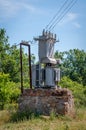 Electrical transformer on a stone stand. Old high-voltage power station. Royalty Free Stock Photo