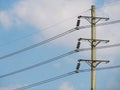 Electrical Transmission power line tower post pole against blue sky