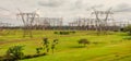 electrical transmission power lines and towers in a green field Royalty Free Stock Photo