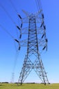 Transmission tower countryside by blue sky