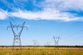 Electrical transmission towers and power lines on fields Royalty Free Stock Photo