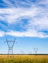 Electrical transmission towers and power lines on fields Royalty Free Stock Photo