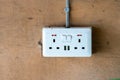 Electrical utility plug in box, found in Uganda Africa. Three prong fitting with USB outlets. Concept for Load shedding, power