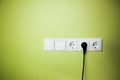 Electrical wall outlet / on green background Royalty Free Stock Photo