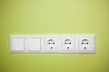 Electrical wall outlet / on green background Royalty Free Stock Photo