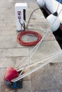 Electrical and water supply pedestal , a bitt and a rope on the Royalty Free Stock Photo