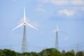 electrical wind farm power energy production, wind turbine eco energy production in nature between the trees Royalty Free Stock Photo