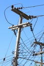 Electrical wire on pole. chaotic wire with nest on pole and blue sky background. Royalty Free Stock Photo