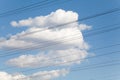 Electrical wires against blue sky and beautiful clouds Royalty Free Stock Photo