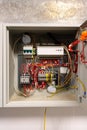 Electrical wiring inside a control box with various connected components in a modern building setting Royalty Free Stock Photo